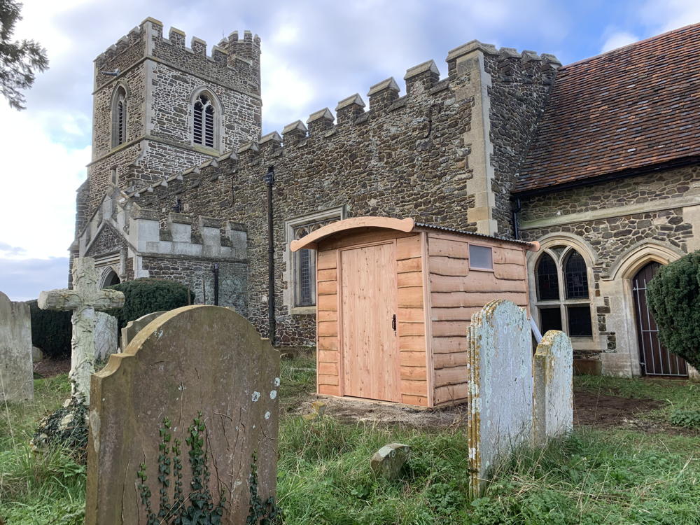 Compost toilet installed beside historic church building.