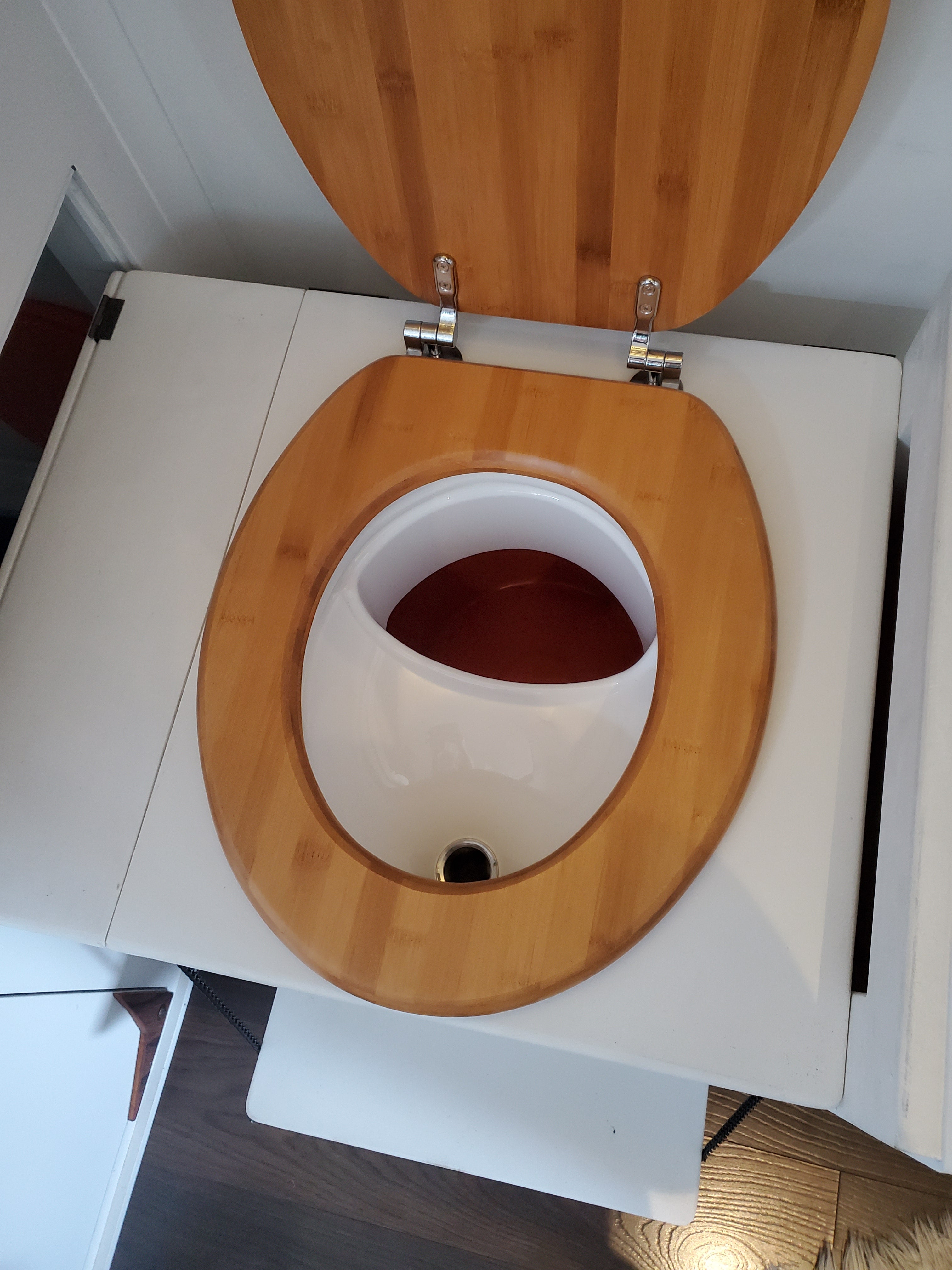 Urine separator installed in wooden compost toilet seat