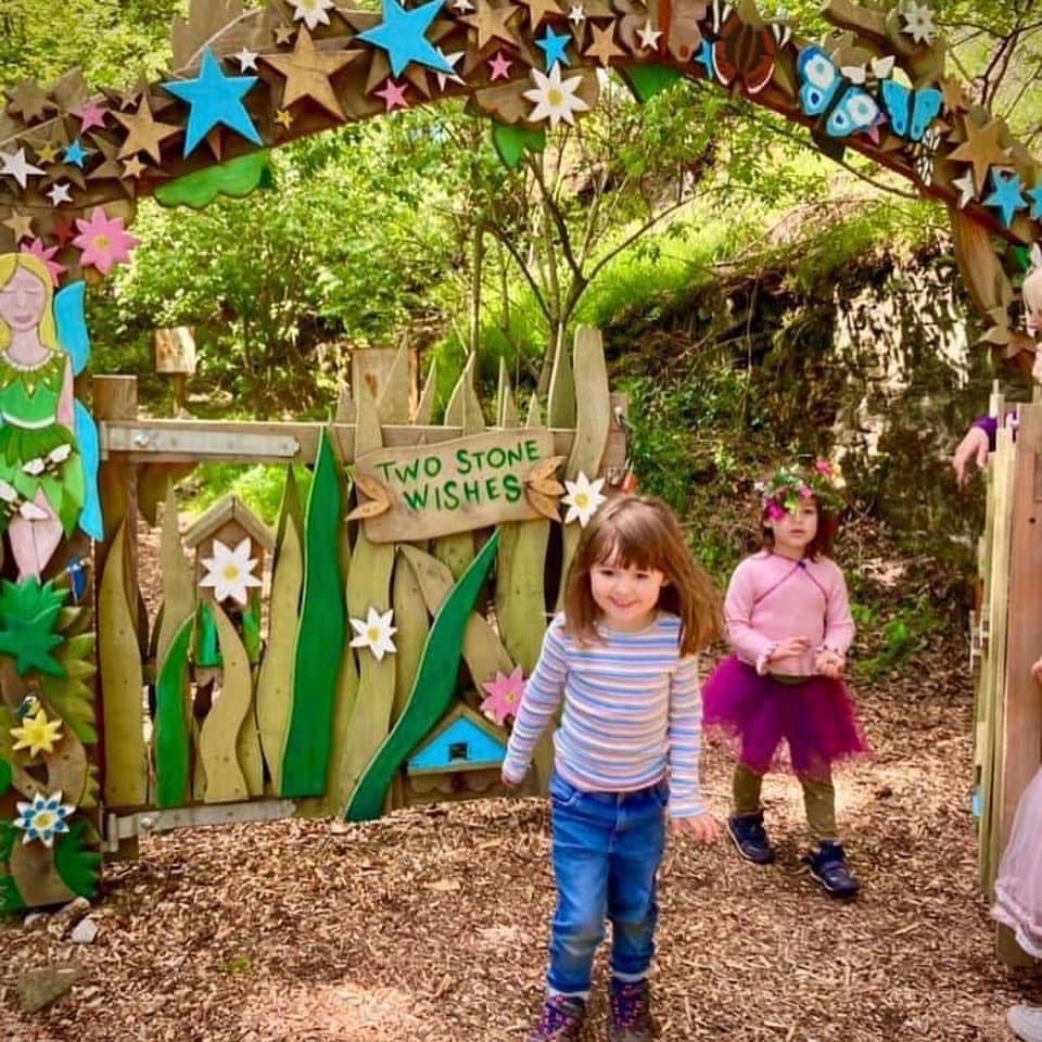 Children playing near fairy-themed gate at Studfold