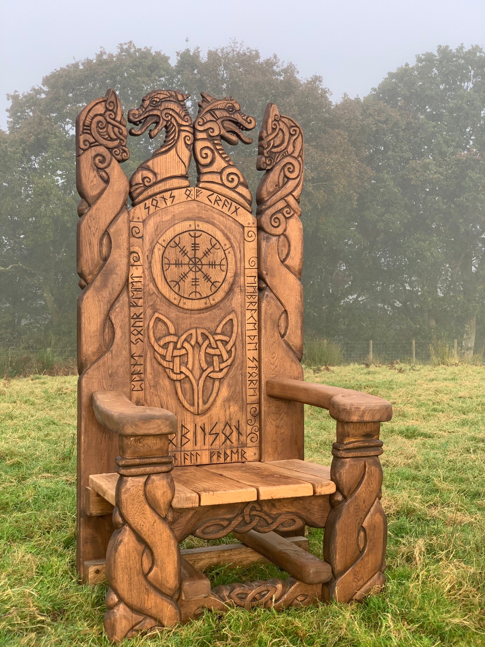 Viking chair with Celtic designs in a grassy field