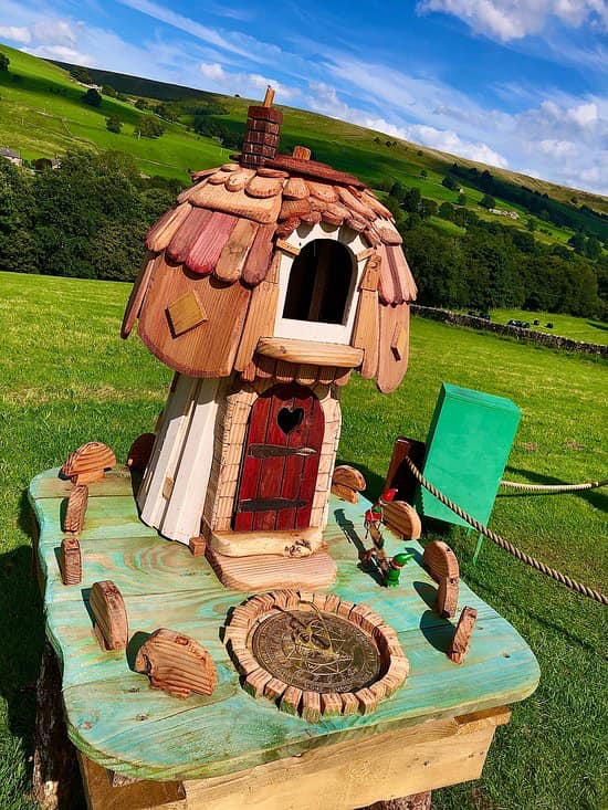 Fairy house with a heart-shaped door in a field