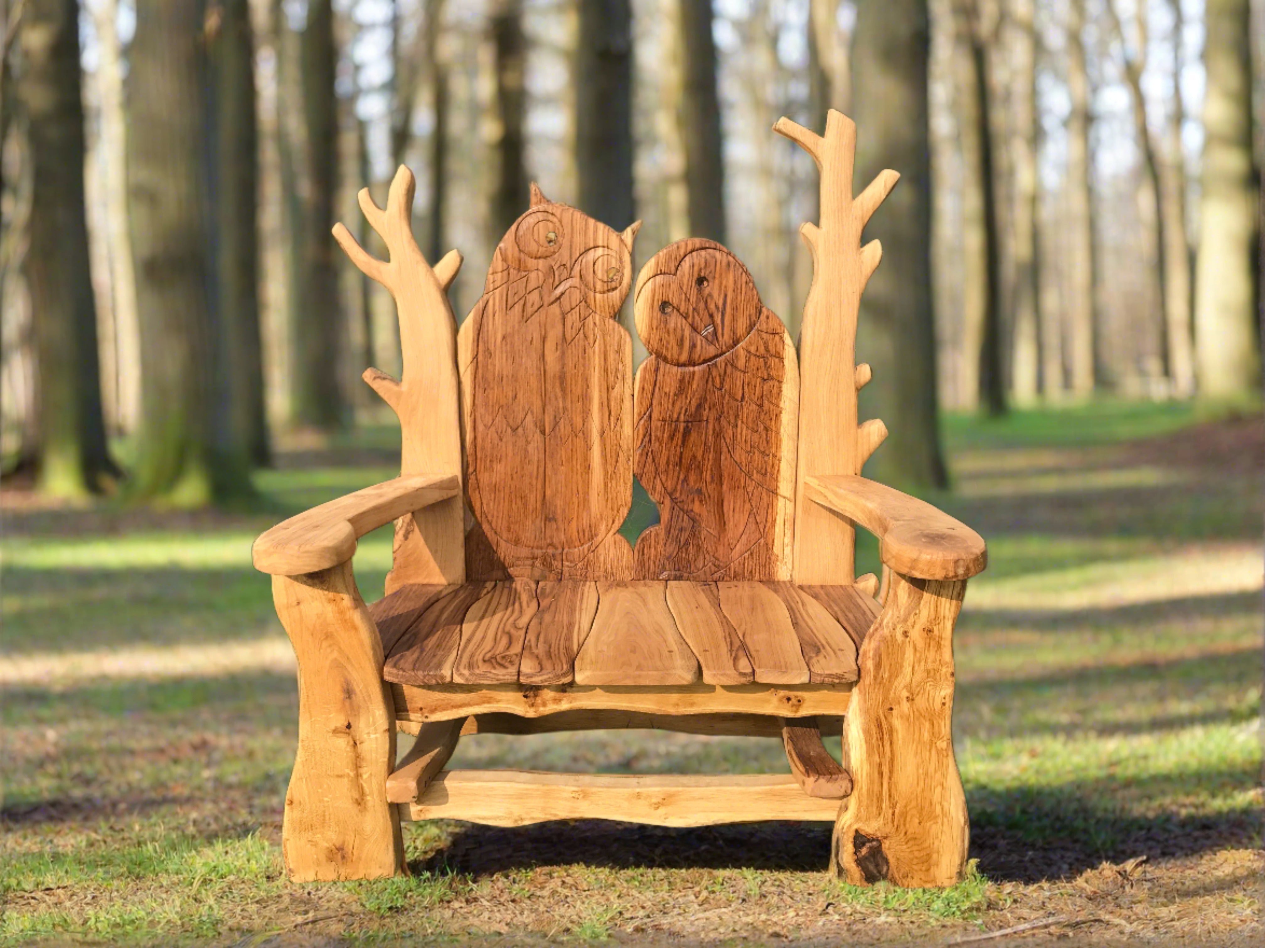 Wooden bench with owl carvings in forest setting