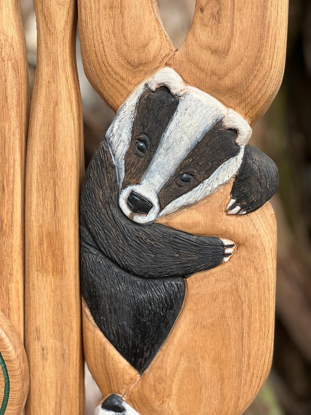 Close-up of carved badger on chair