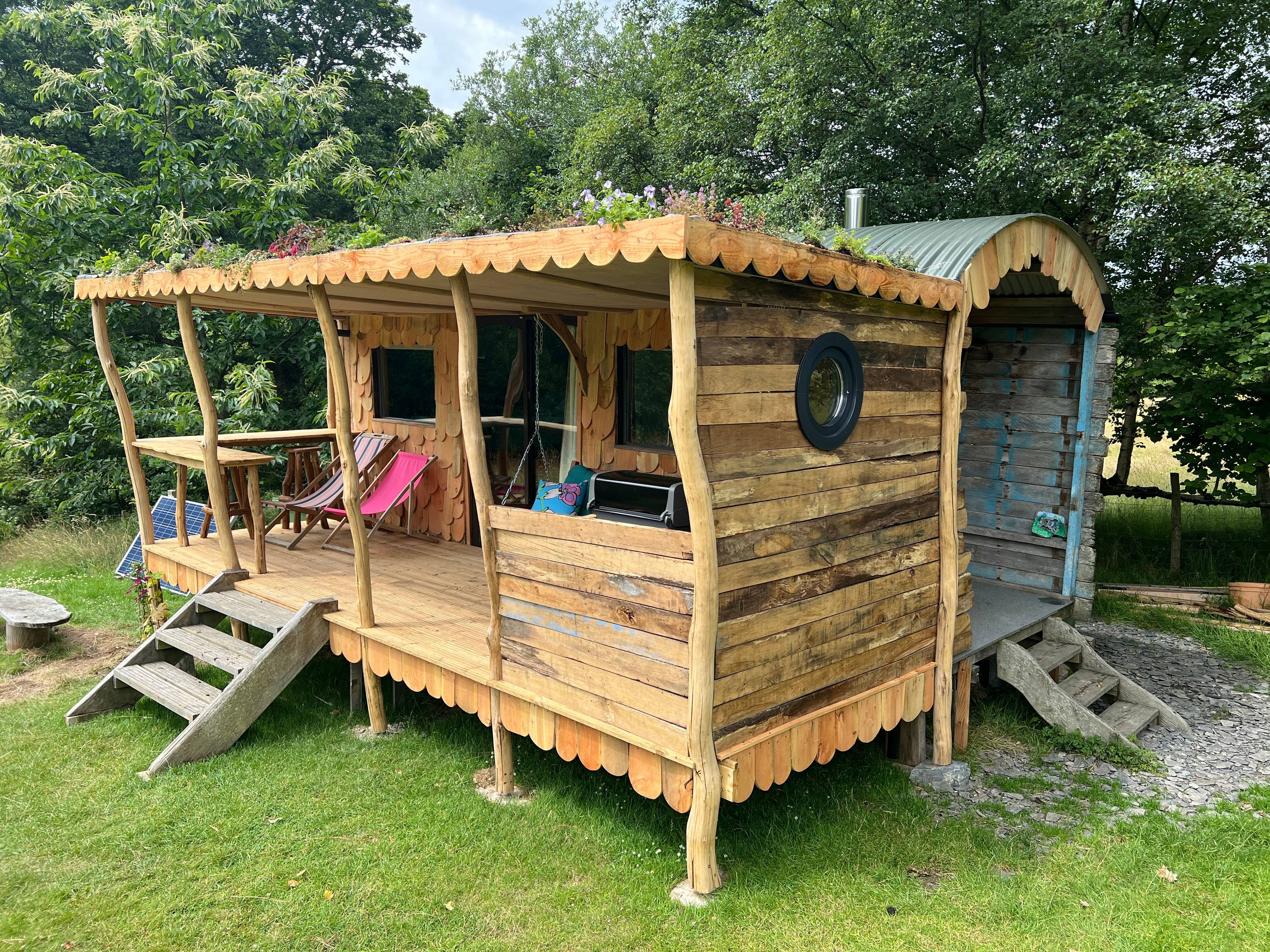 Wooden shepherd's hut with porch and seating