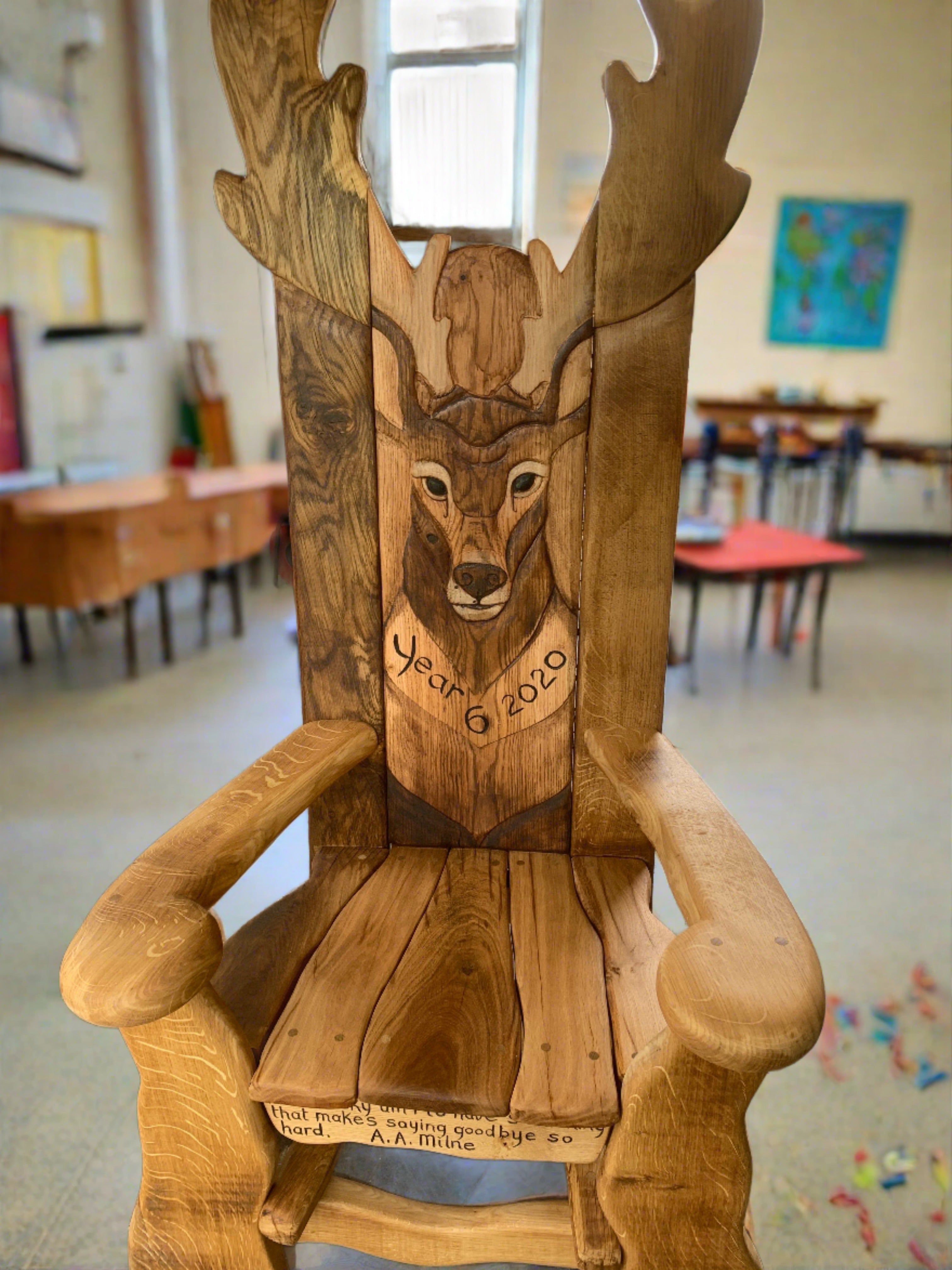 Wooden bench with deer carving and dedication