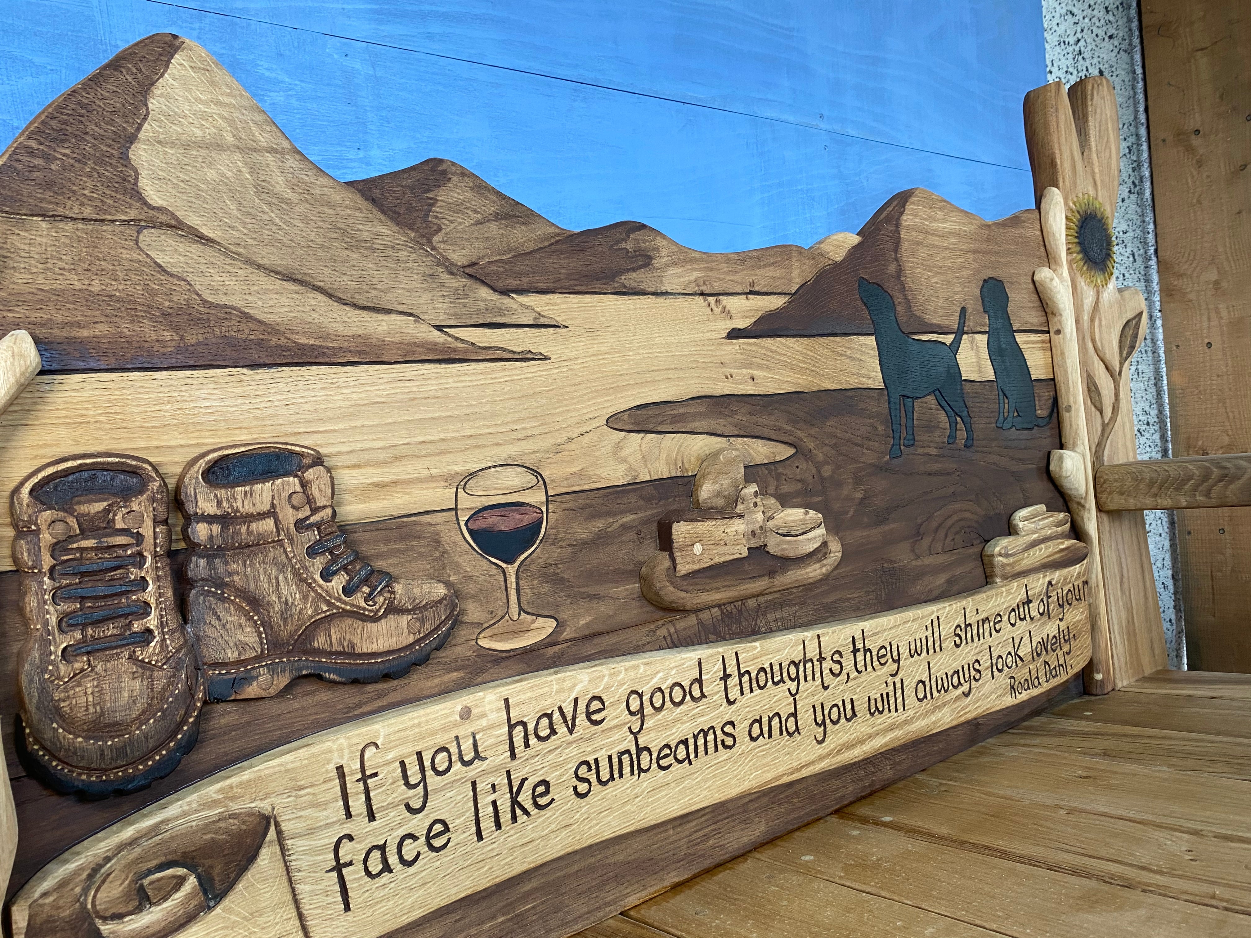 Close-up of bench with mountain scene and quote.