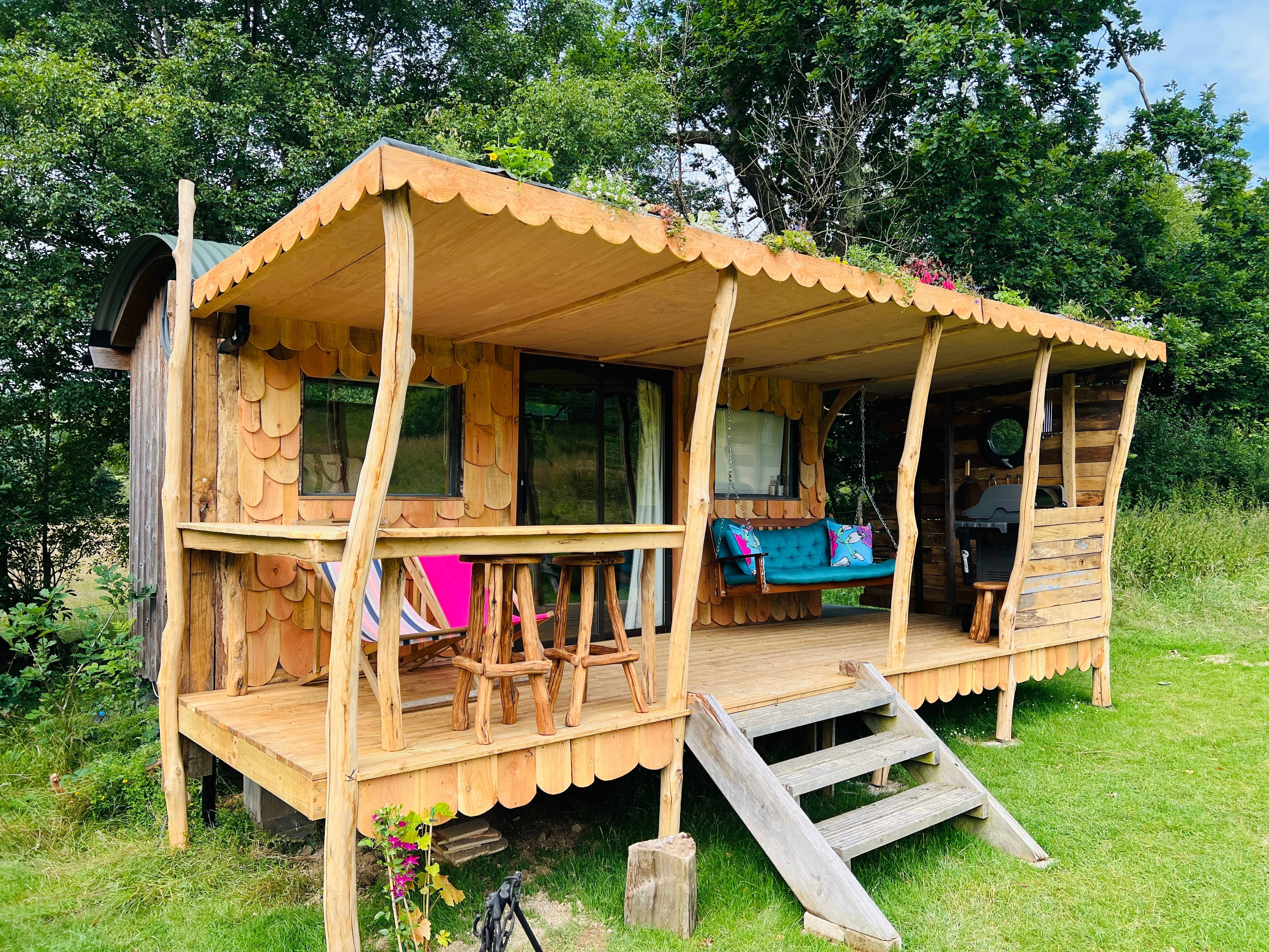 Shepherd's hut with porch and wooden bar seating