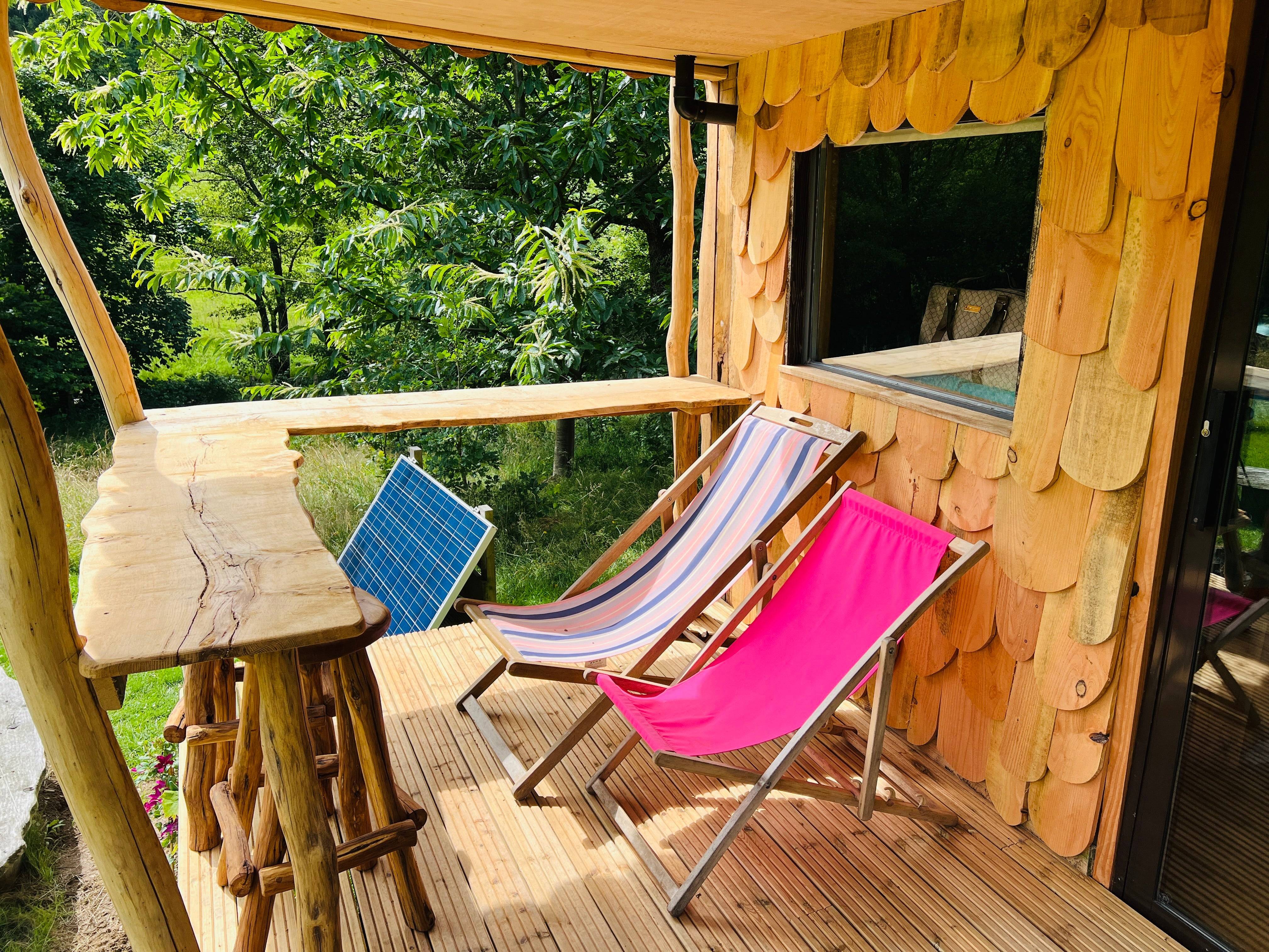 Deck chairs on porch of wooden shepherd's hut