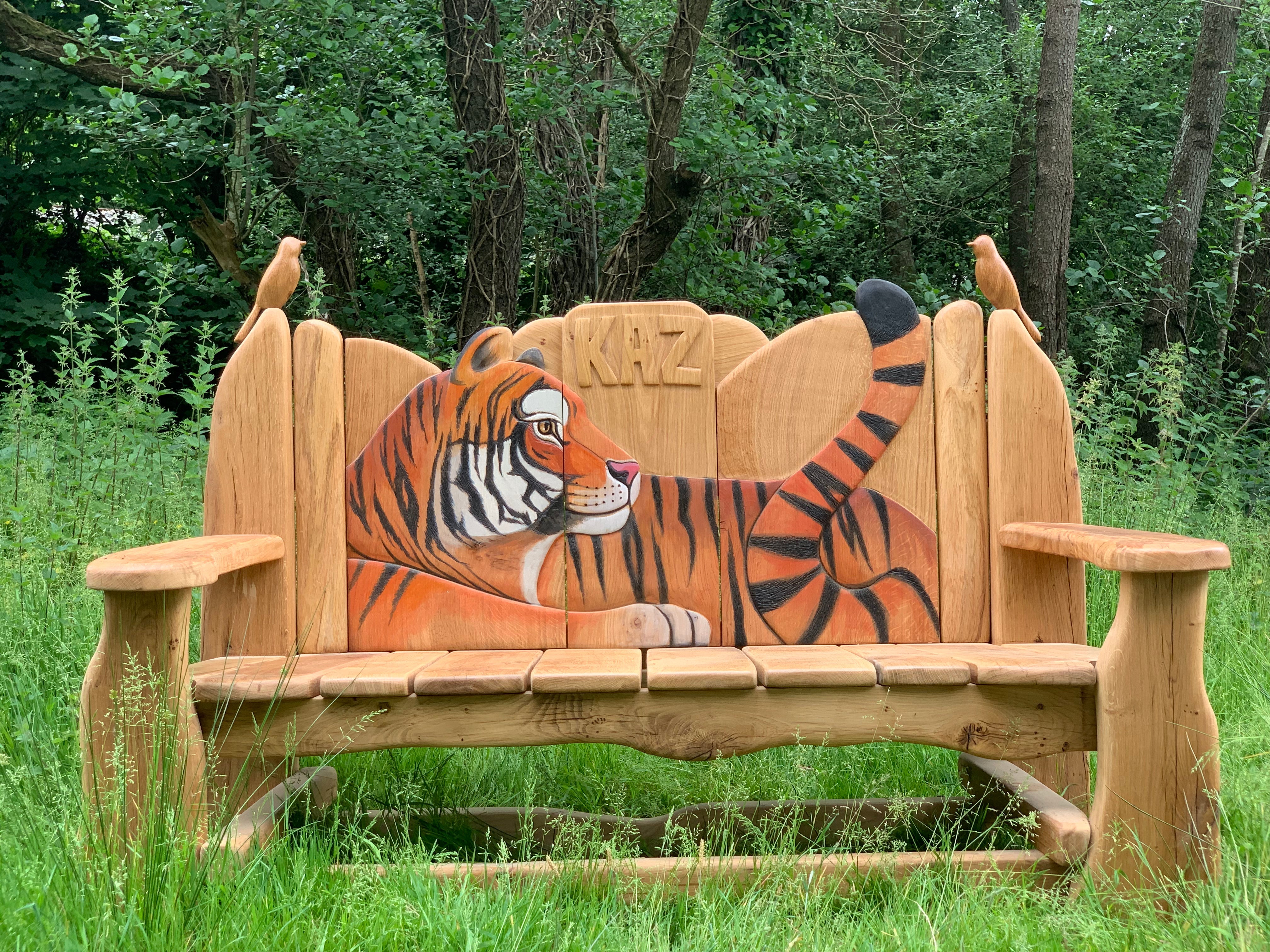 Tiger-themed wooden bench in lush greenery