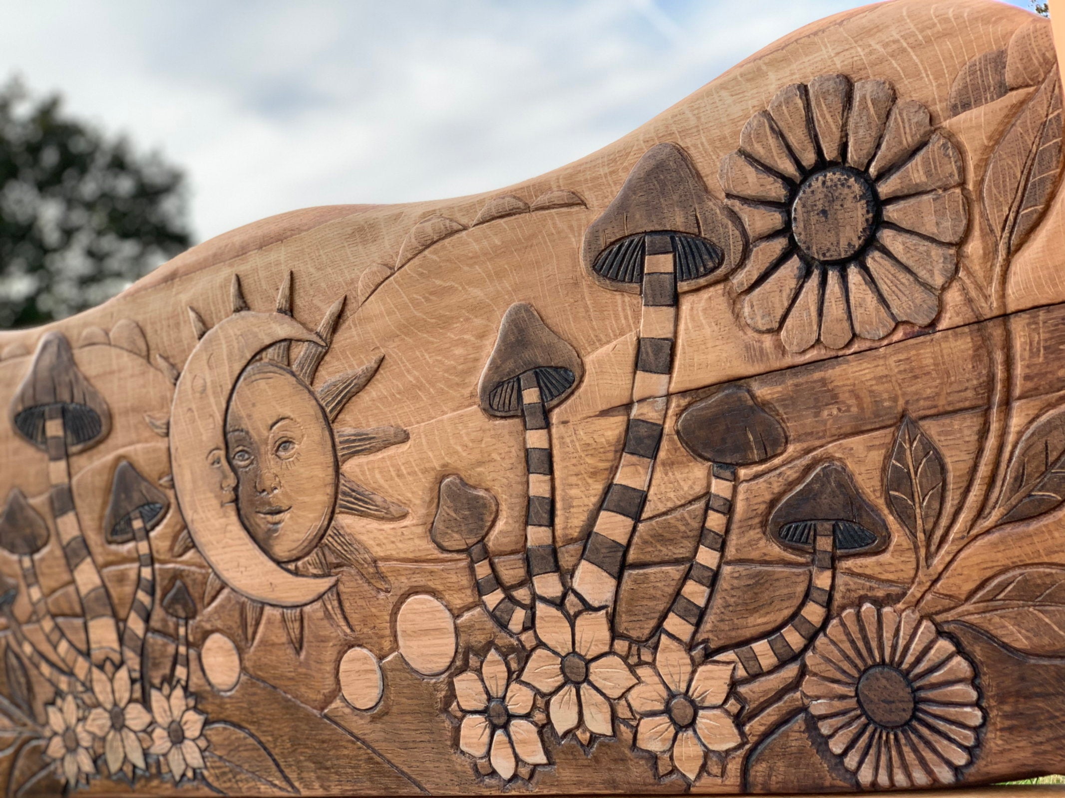 Detailed carving of mushrooms and flowers on oak bed