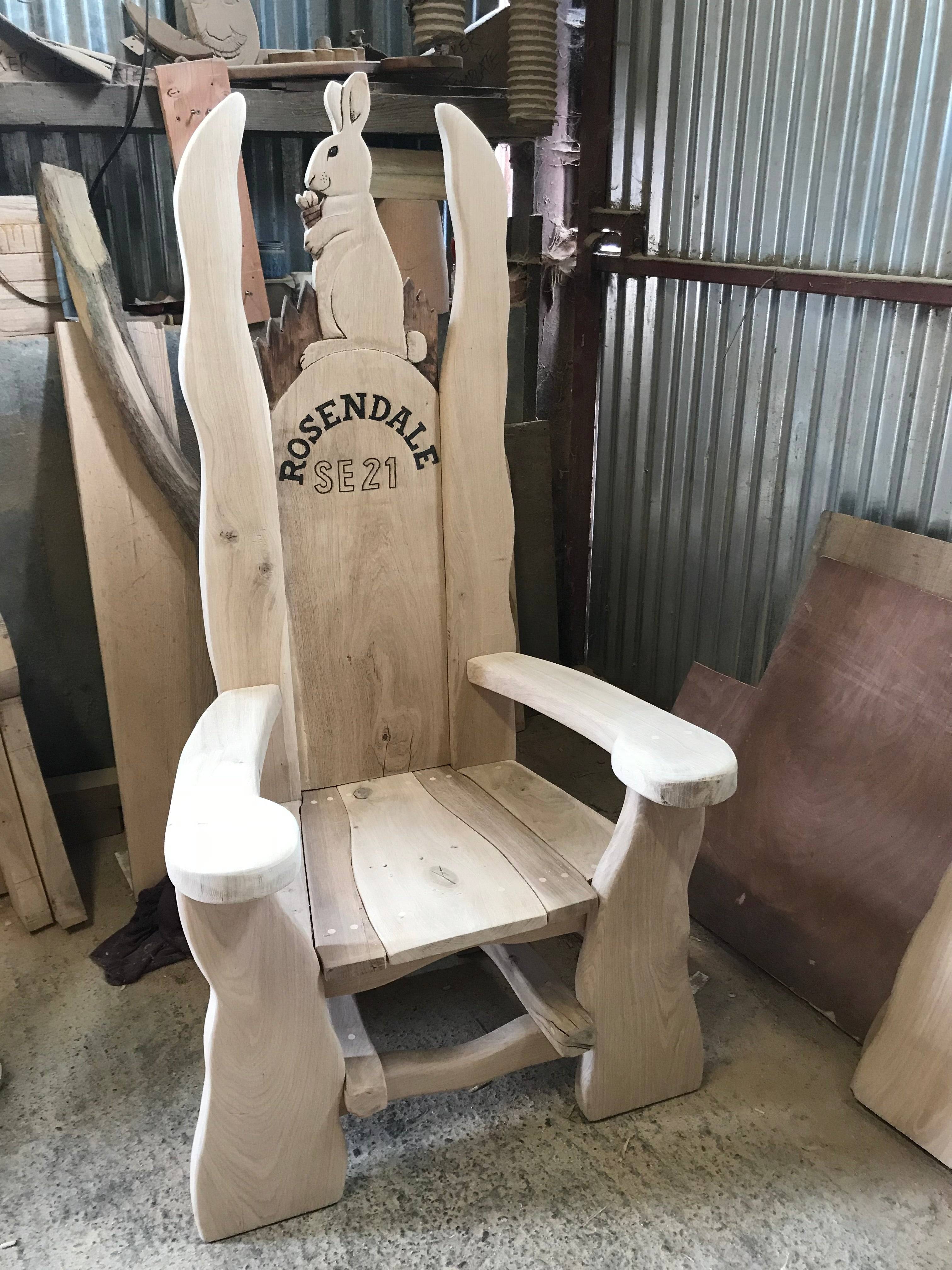 Oak chair with rabbit carving in workshop setting