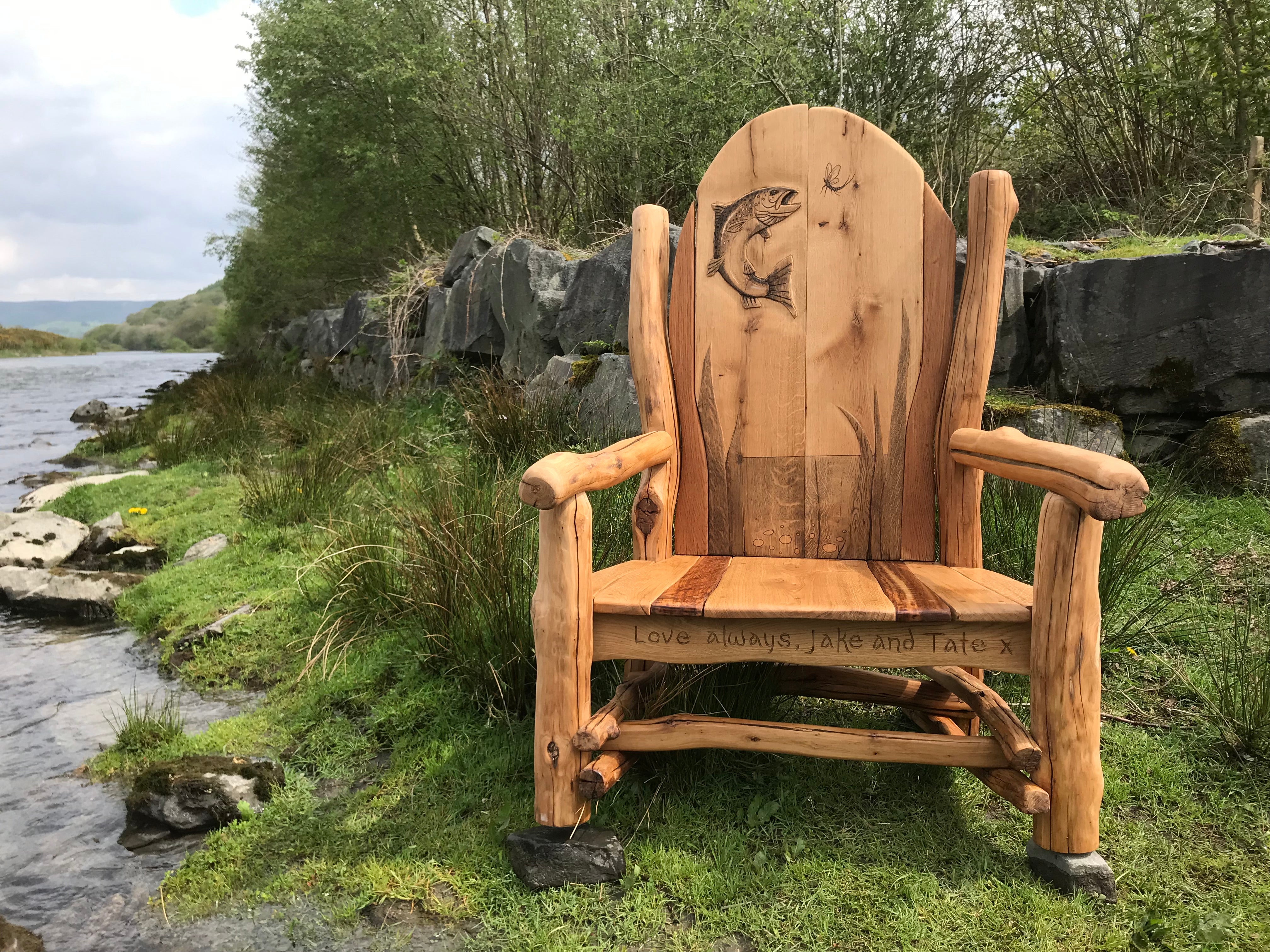 Wooden bench with fish carving by riverside