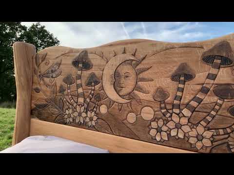 Close-up of carved mushroom and sun details on bed