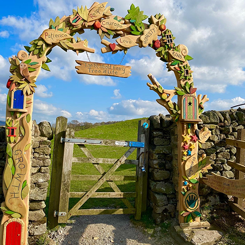 Decorative wooden archway with positive words and fairy theme