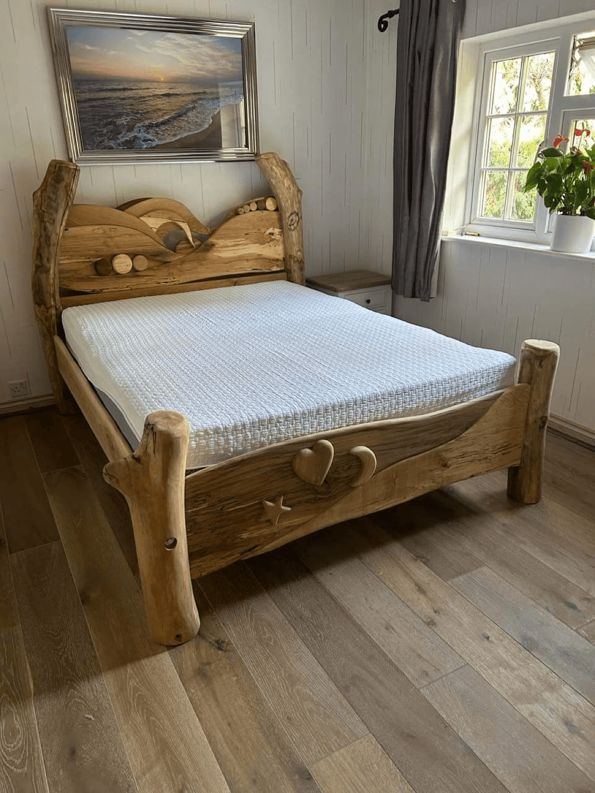 Natural wood bed with heart and star carvings