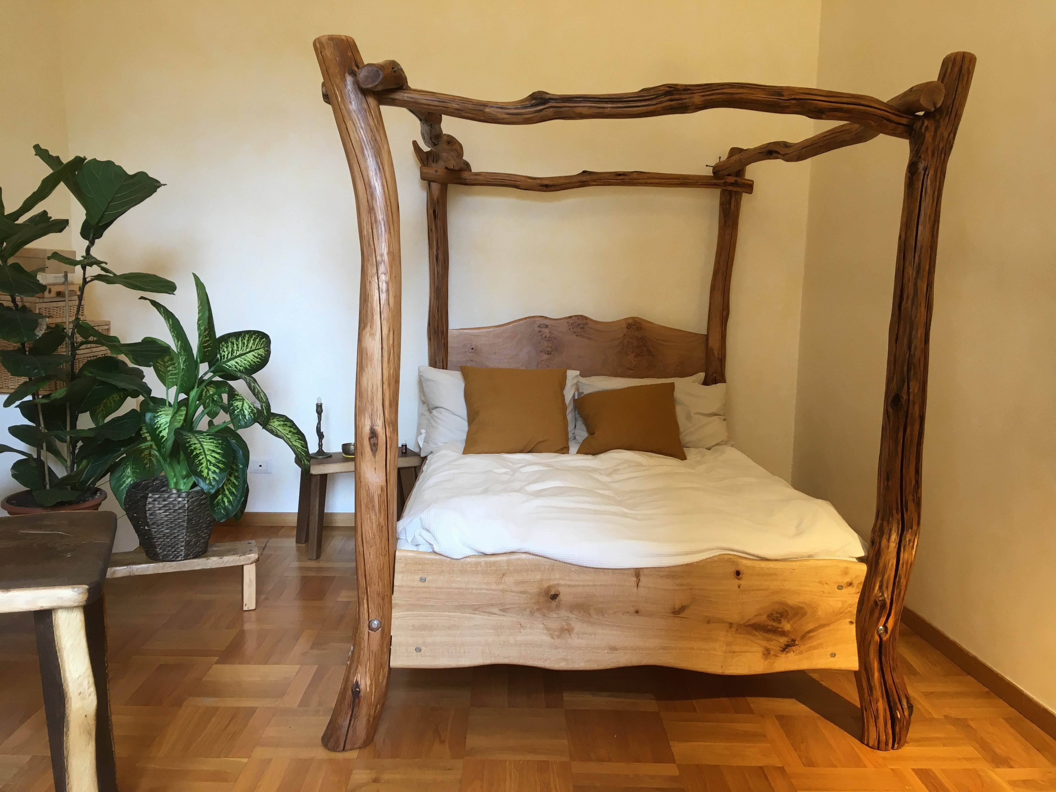 Bespoke driftwood bed with pillows in room