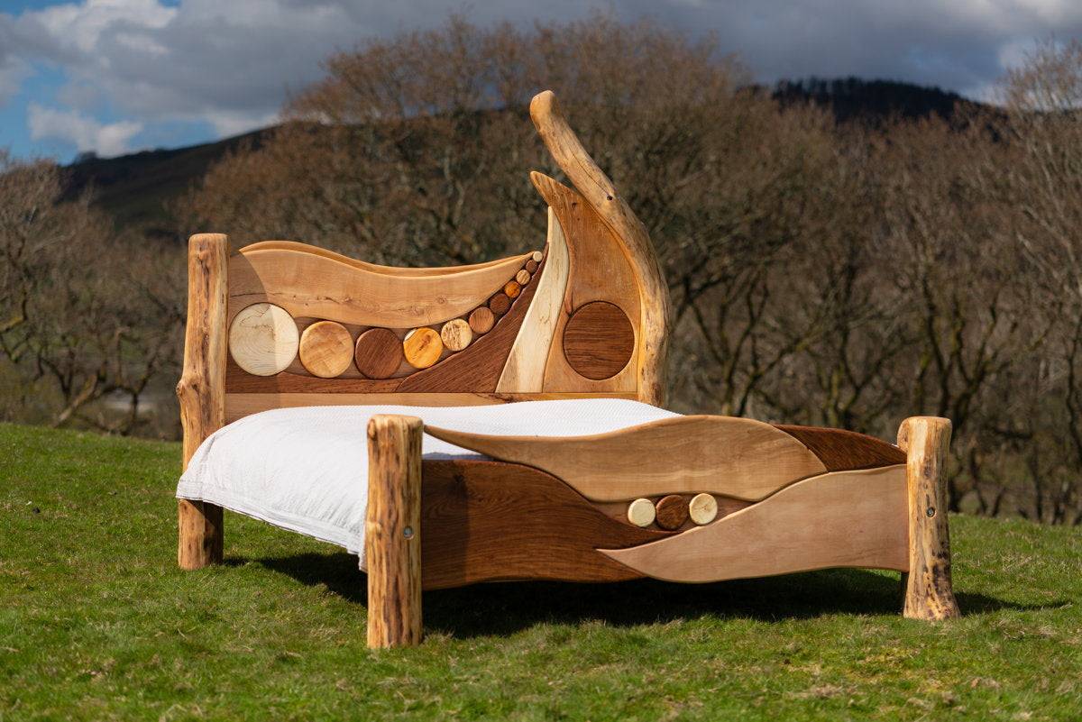 Rustic driftwood bed frame on grassy landscape