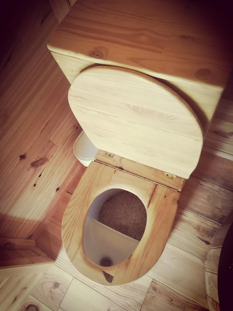 Wooden compost toilet with urine separator, top view.