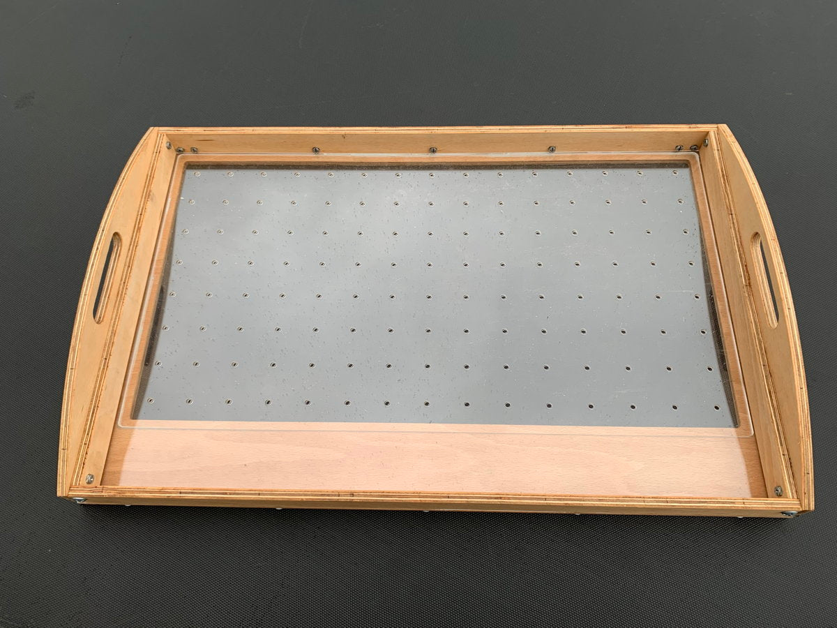 Mechanical seed sowing tray with perforated surface