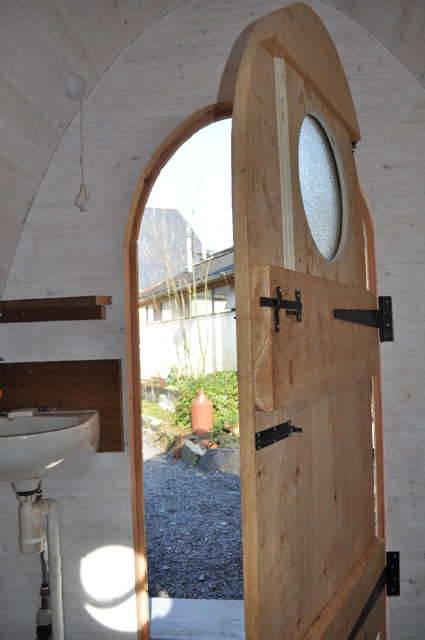 Open door of Timber Arc Composting Toilet showing interior