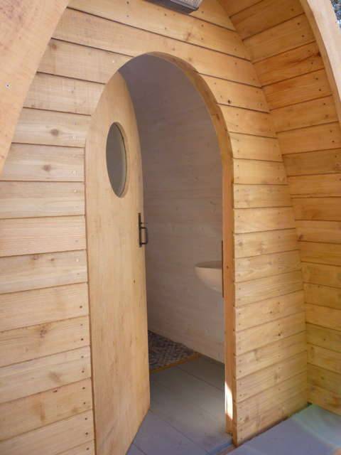 Entrance of Timber Arc Composting Toilet with wooden door