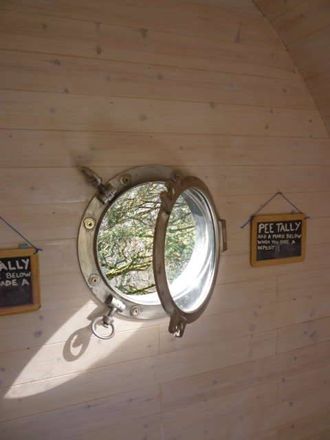 Interior window and signs inside Timber Arc Composting Toilet