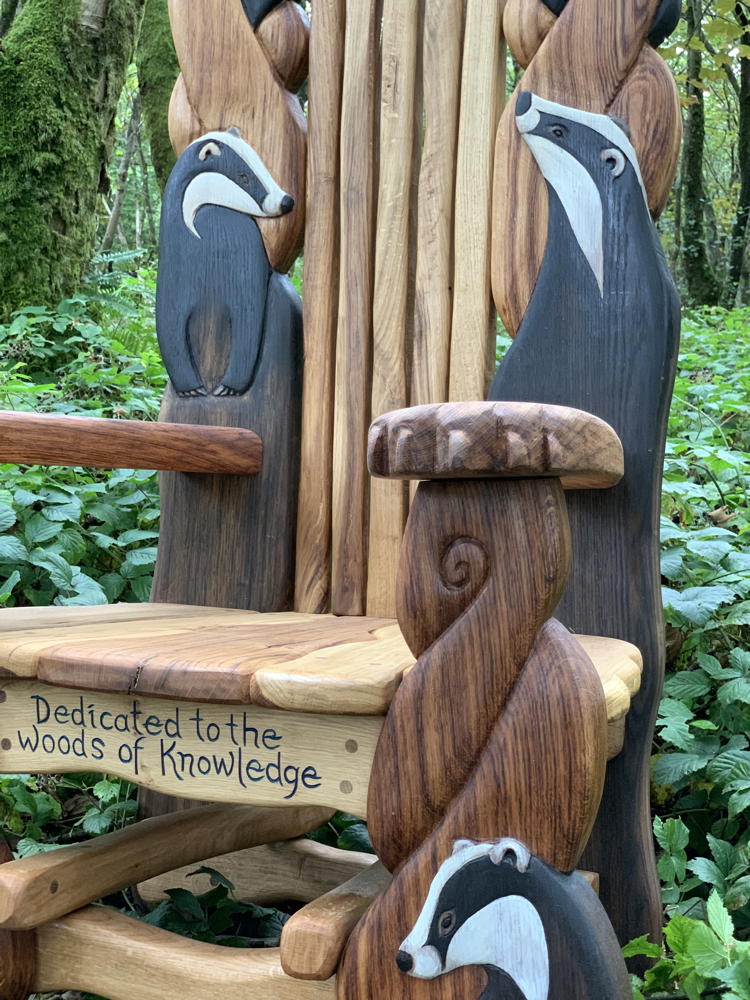 Side view of badger carvings on wooden chair