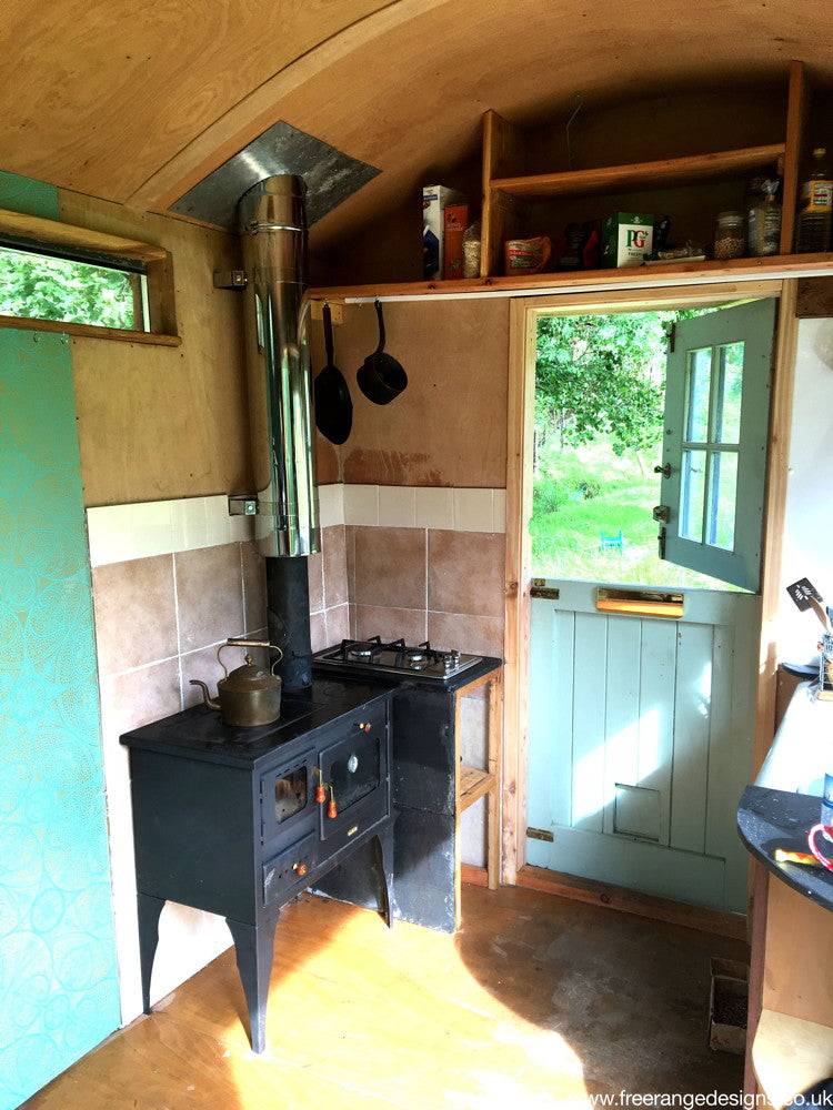 Cozy interior of shepherd's hut with stove and door