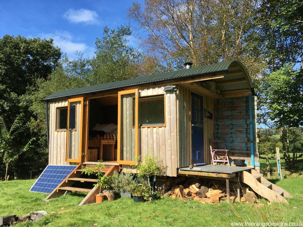 Wooden shepherd's hut with solar panel and steps