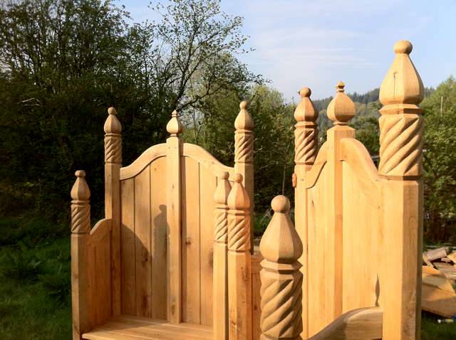 Close-up of ornate carved chair tops in outdoor setting