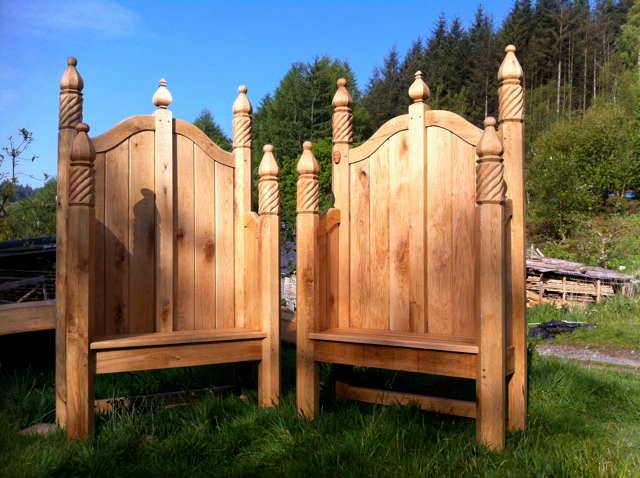 Two storytelling chairs with carved details in garden