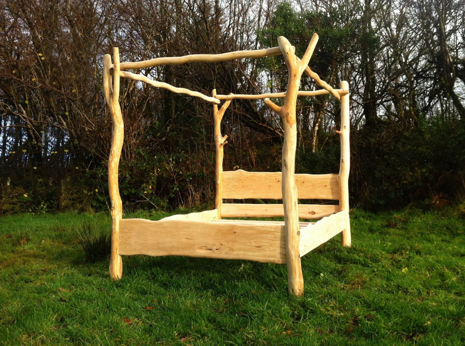 Sustainable driftwood bed in grassy area