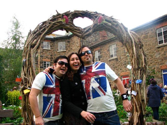 Group posing under driftwood arch at event