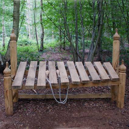 Large oak outdoor wooden xylophone in forest setting