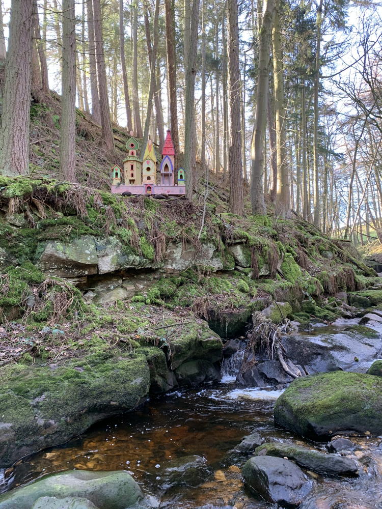 Fairy village on a hillside by a stream