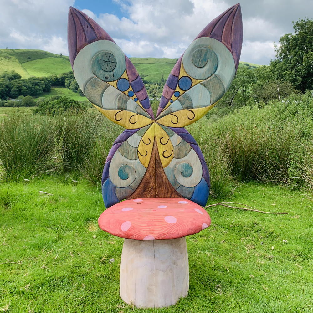 Mushroom fairy chair with large butterfly wings outdoors