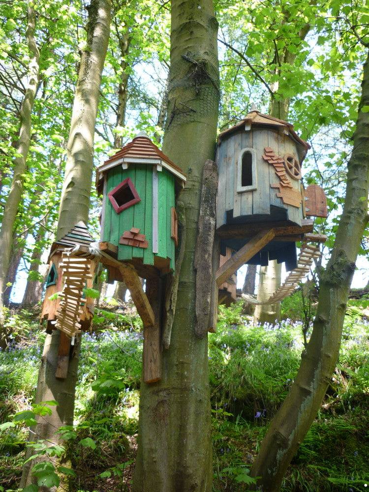 Tree-mounted fairy houses with wooden walkways