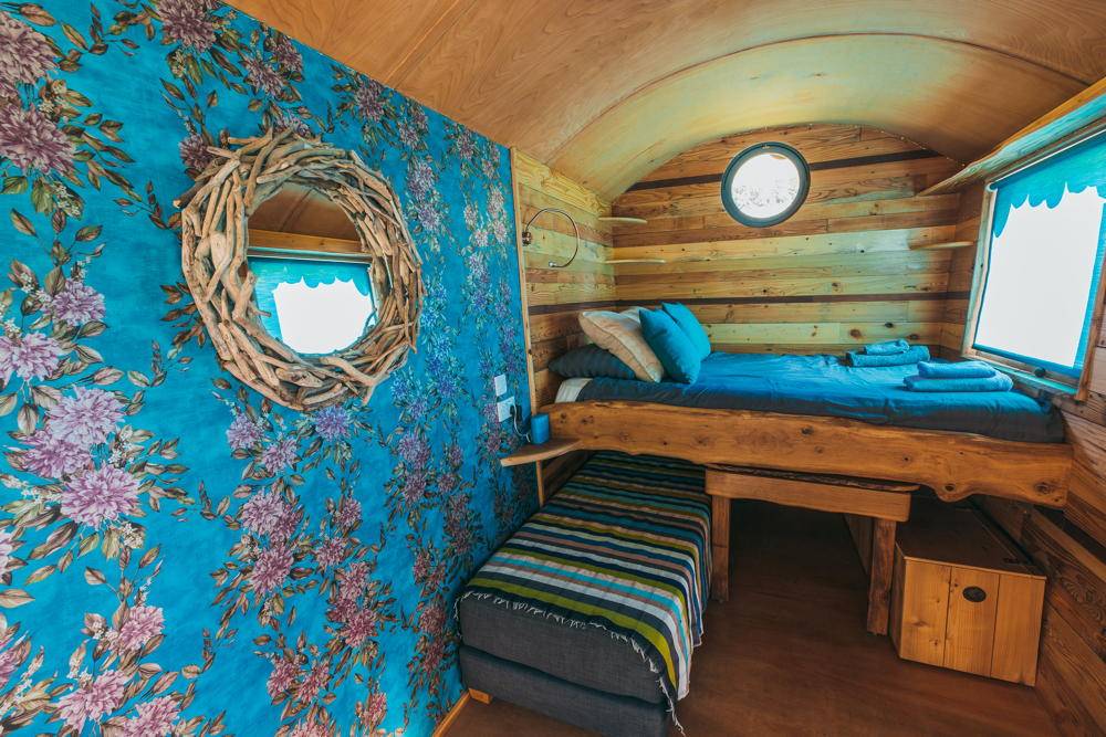 Floral interior decor in Shepherd's Hut with bed