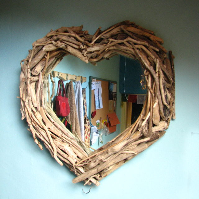 Driftwood heart mirror reflecting indoor decor