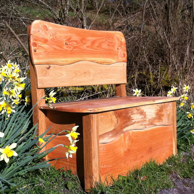 Wooden bench with storage in a garden setting