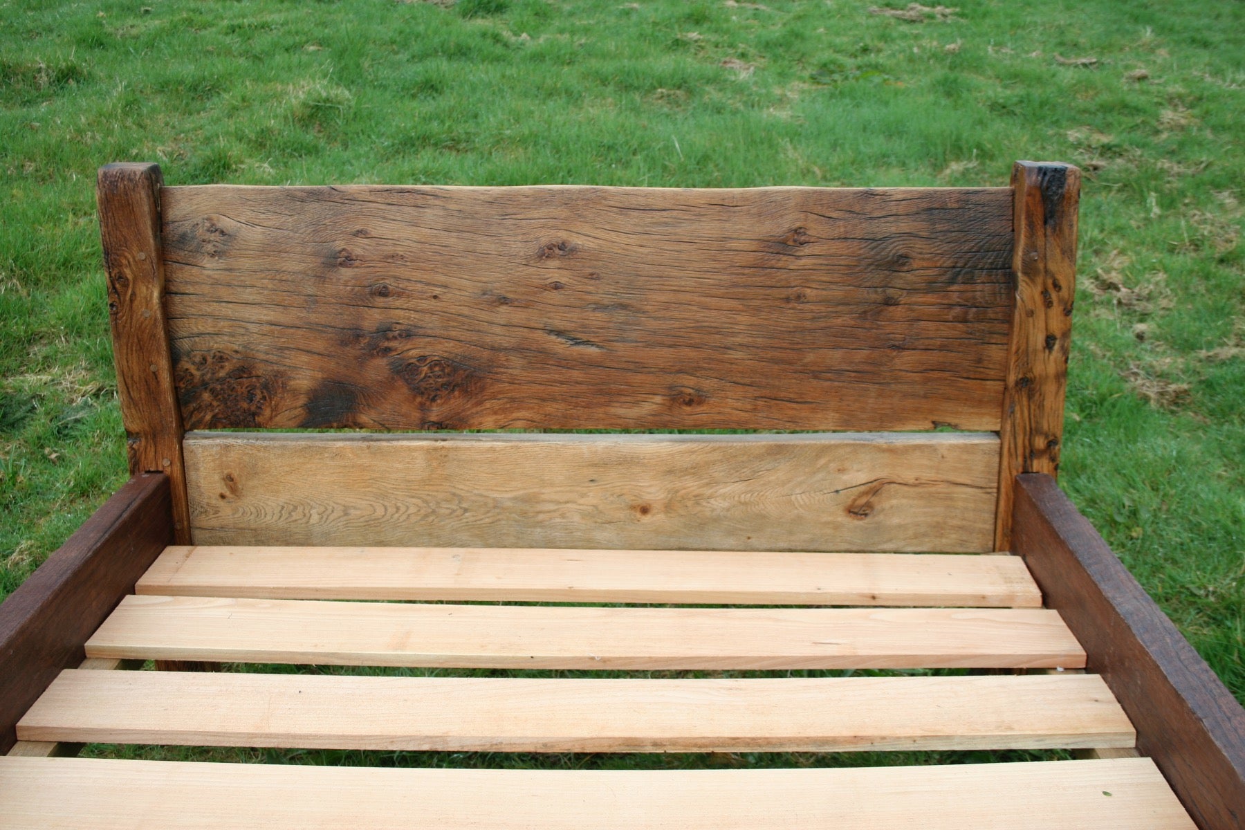 Close-up of rustic oak bed headboard