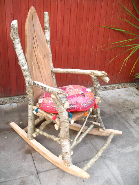 Rustic wooden rocking chair with colorful cushion