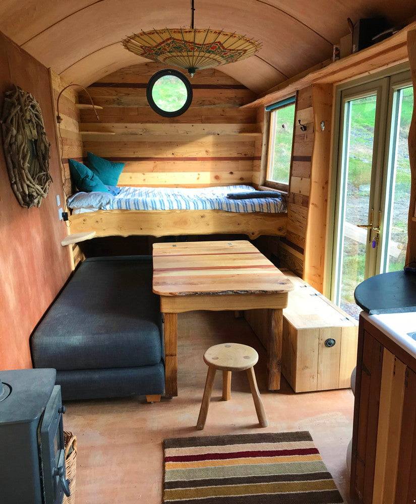 Interior view of Shepherd's Hut with table and bed