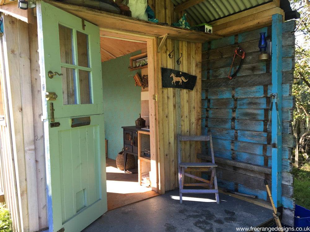 Open door of shepherd's hut showing interior